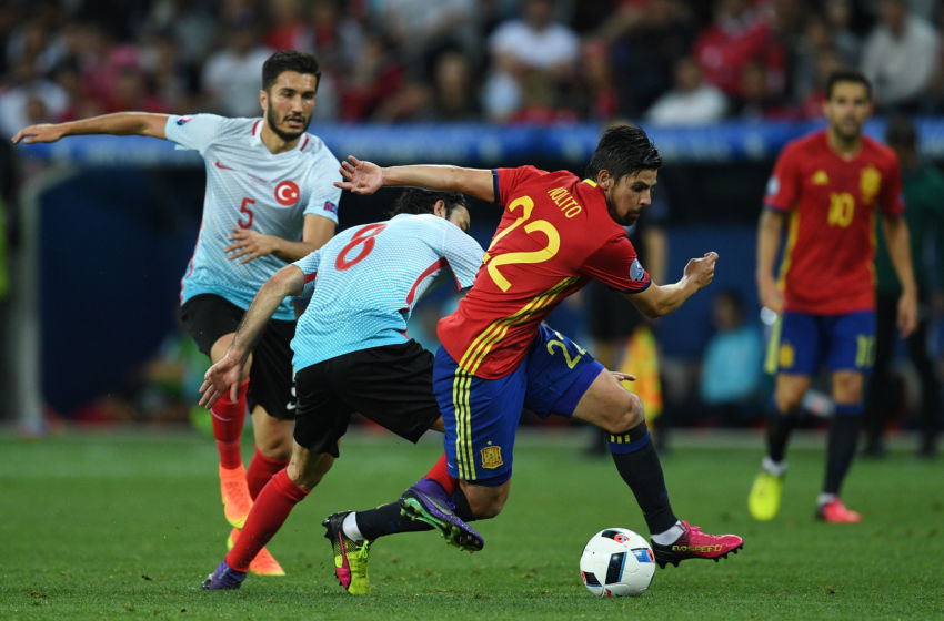 NICE, FRANCE - JUNE 17:  Selcuk Inan of Turkey attempts to tackle Nolito of Spain during the UEFA EURO 2016 Group D match between Spain and Turkey at Allianz Riviera Stadium on June 17, 2016 in Nice, France.  (Photo by David Ramos/Getty Images)